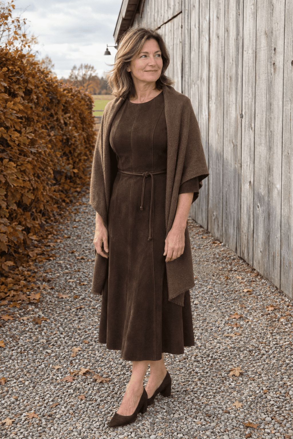 mother of the bride outfit in chocolate brown: elbow-sleeve belted midi dress with a brown cashmere wrap and dark brown suede block-heel pumps