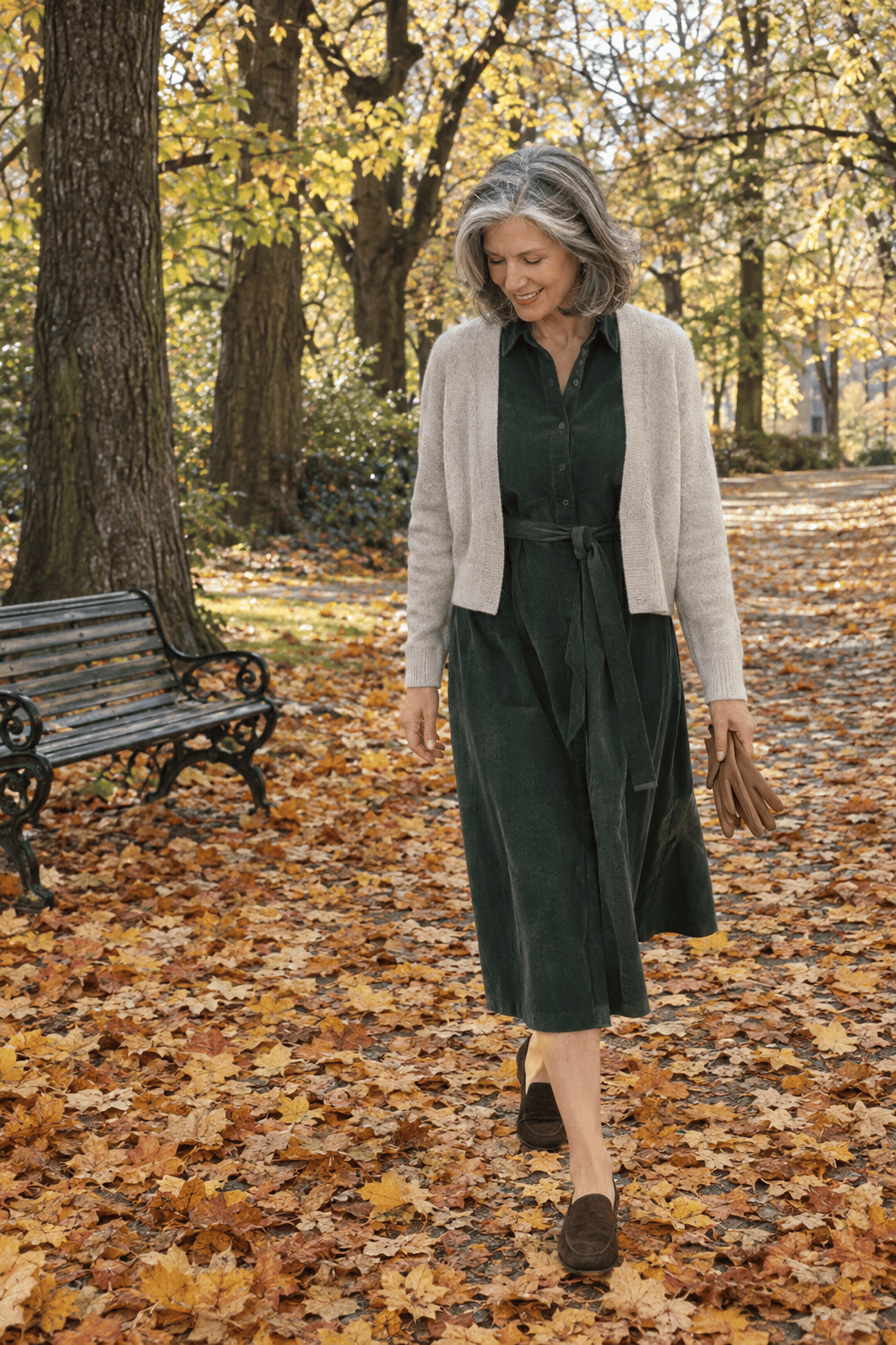 classy fall outfit for women over 60: forest green belted corduroy shirt dress, oatmeal cashmere cardigan and suede loafers