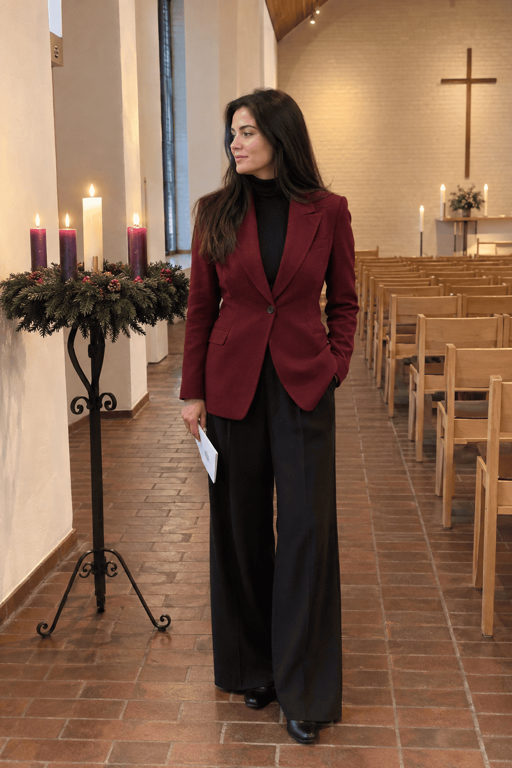 christmas eve church outfit for women: longline wine red blazer over a black turtleneck and black wide-leg trousers