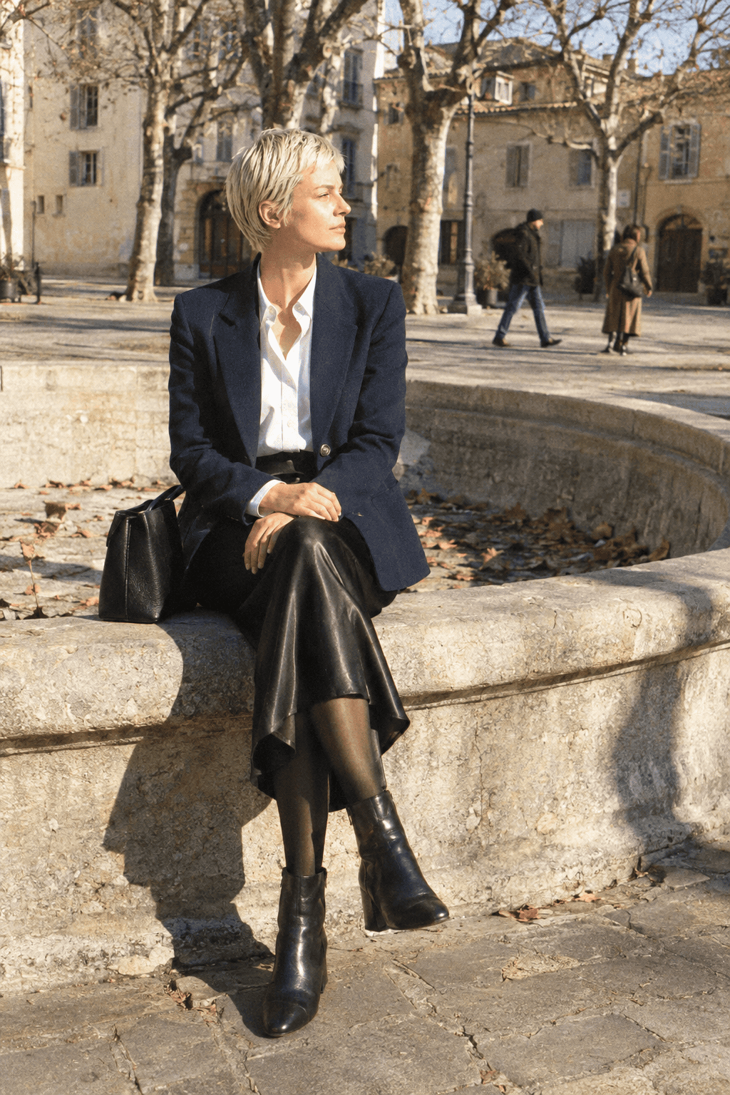 10 piece capsule wardrobe work event outfit: navy wool blazer, white cotton shirt, black column slip skirt and black ankle boots