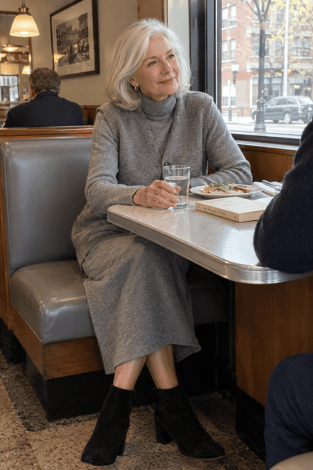 elegant spring outfit for women in their 70s: heather grey cashmere turtleneck dress with a tonal sweater vest and black suede ankle boots