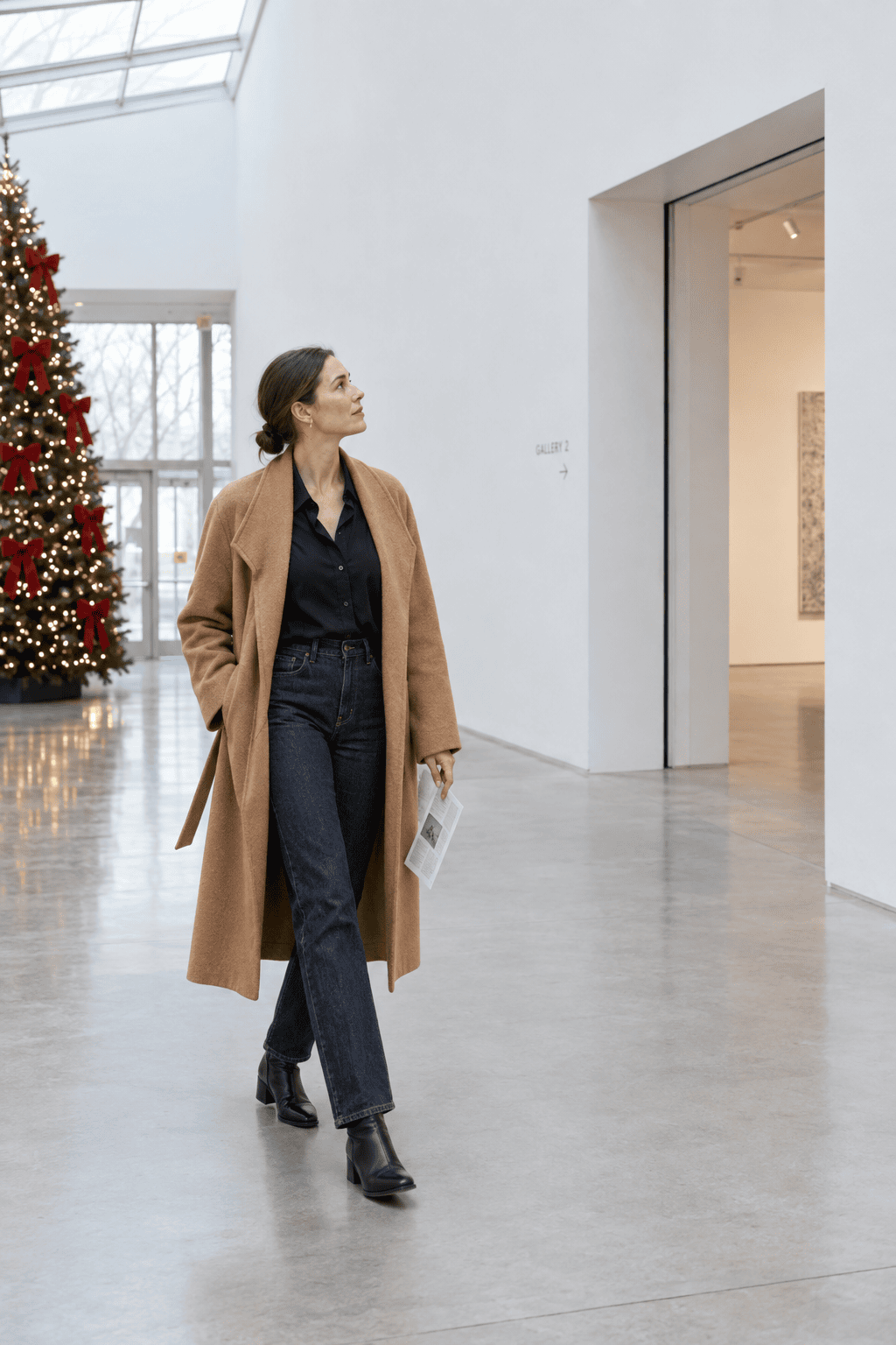holiday capsule wardrobe museum day outfit: caramel wrap coat, black silk shirt, dark indigo jeans and black ankle boots