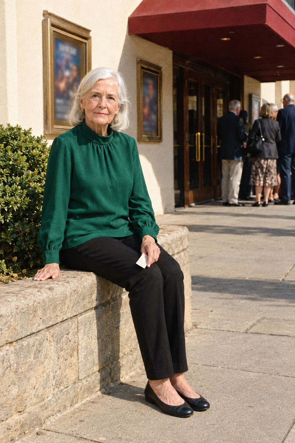 elegant theatre matinee outfit for women in their 80s: deep emerald funnel-neck blouse, black pull-on ponte trousers and black leather ballet flats