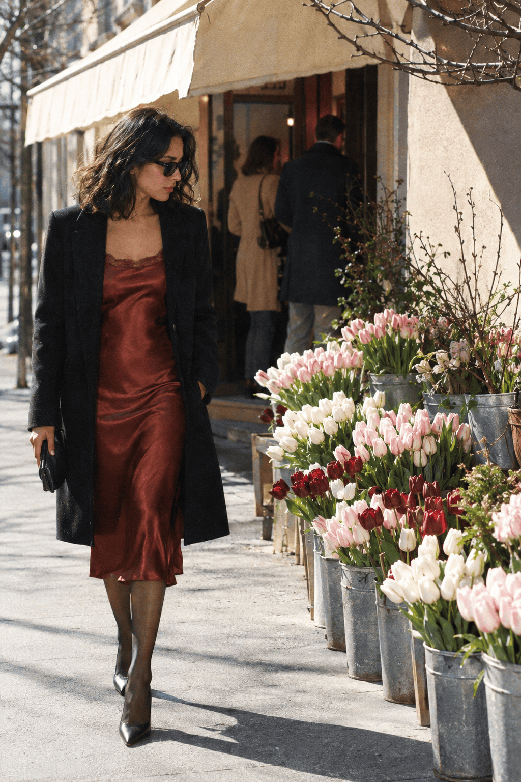 Valentine's Day red dress outfit for date night: muted rust red satin slip dress with a long black wool coat and black pointed pumps