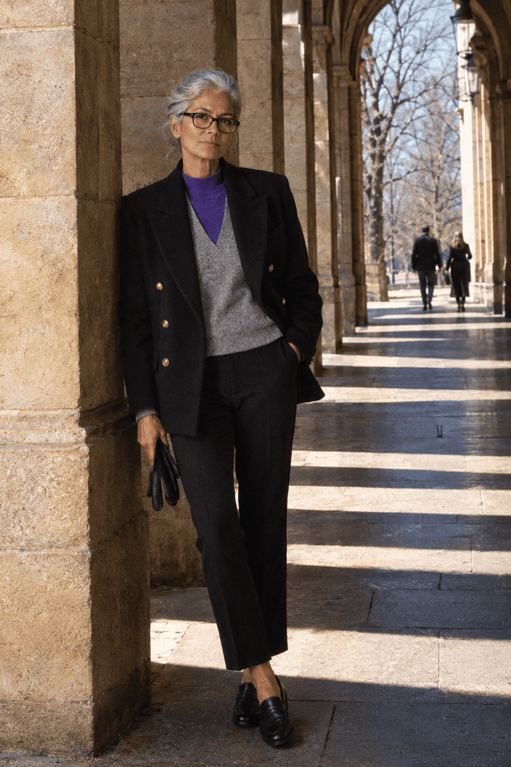 warm winter layering outfit for women over 60: black double-breasted blazer with gold buttons, heather grey cashmere vest and purple cashmere crew
