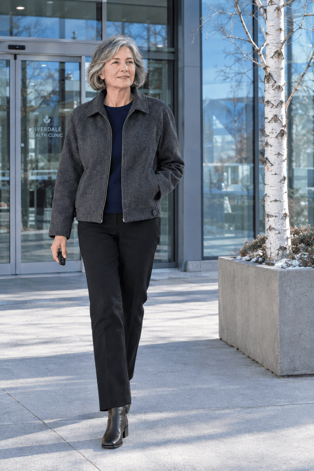 errands outfit for women over 60: dark grey wool Harrington jacket over a navy cashmere sweater, black straight ponte pants and brown boots