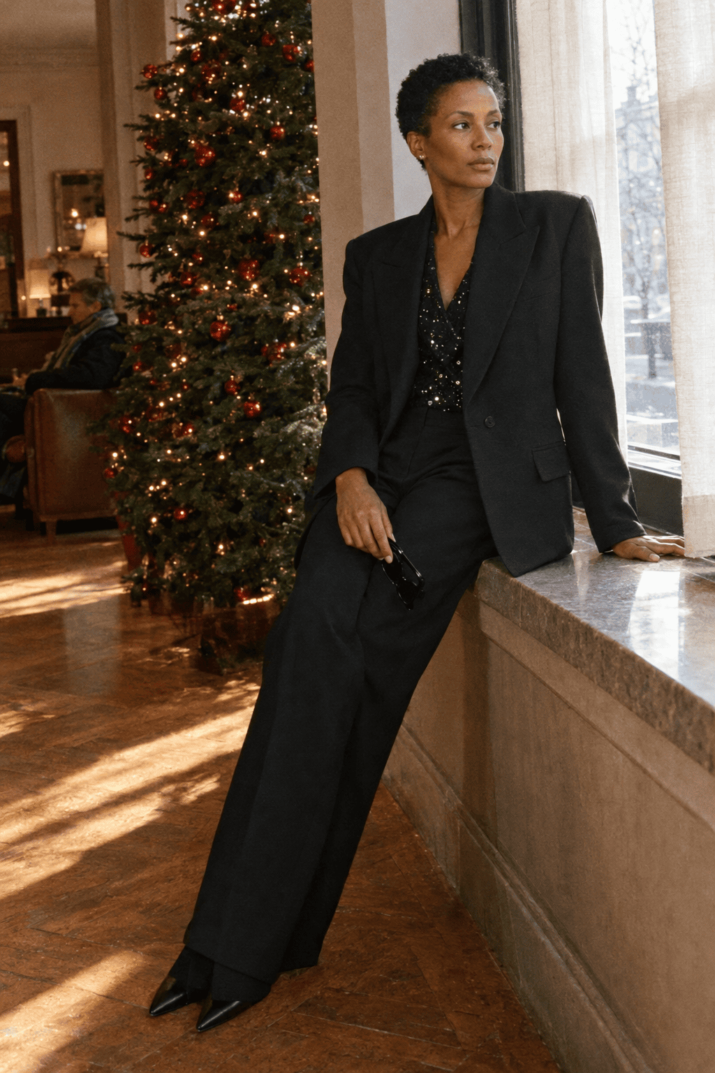 all black christmas party outfit: oversized black blazer, black diamond-sequin blouse and black wide-leg wool trousers