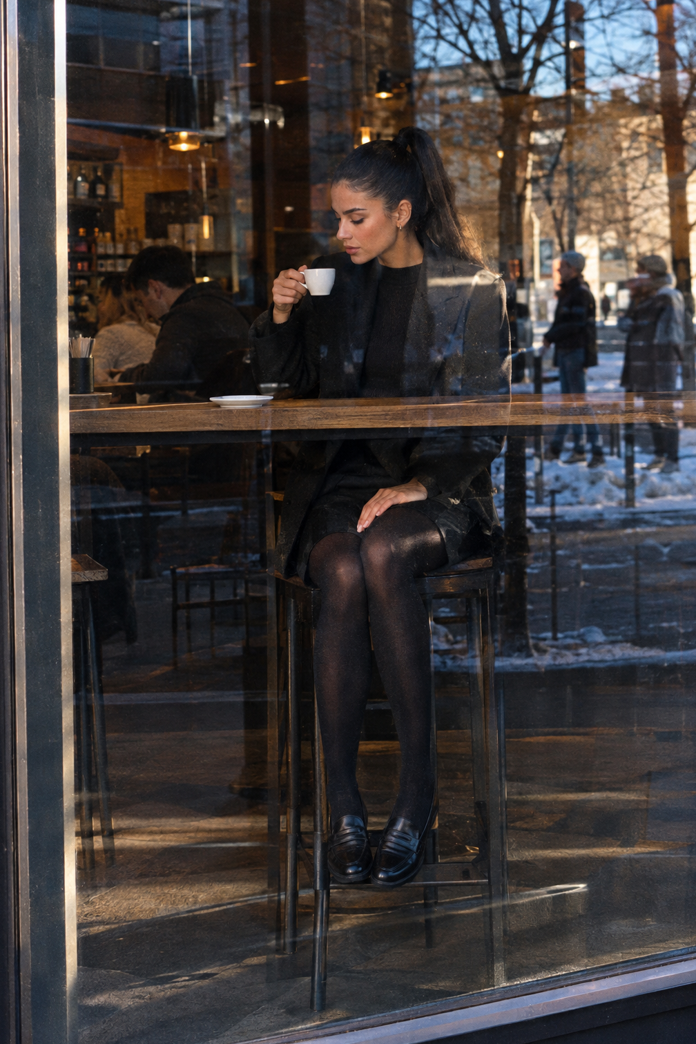 how to style black loafers in winter with black ponte bermuda shorts, opaque black tights and a penny loafer