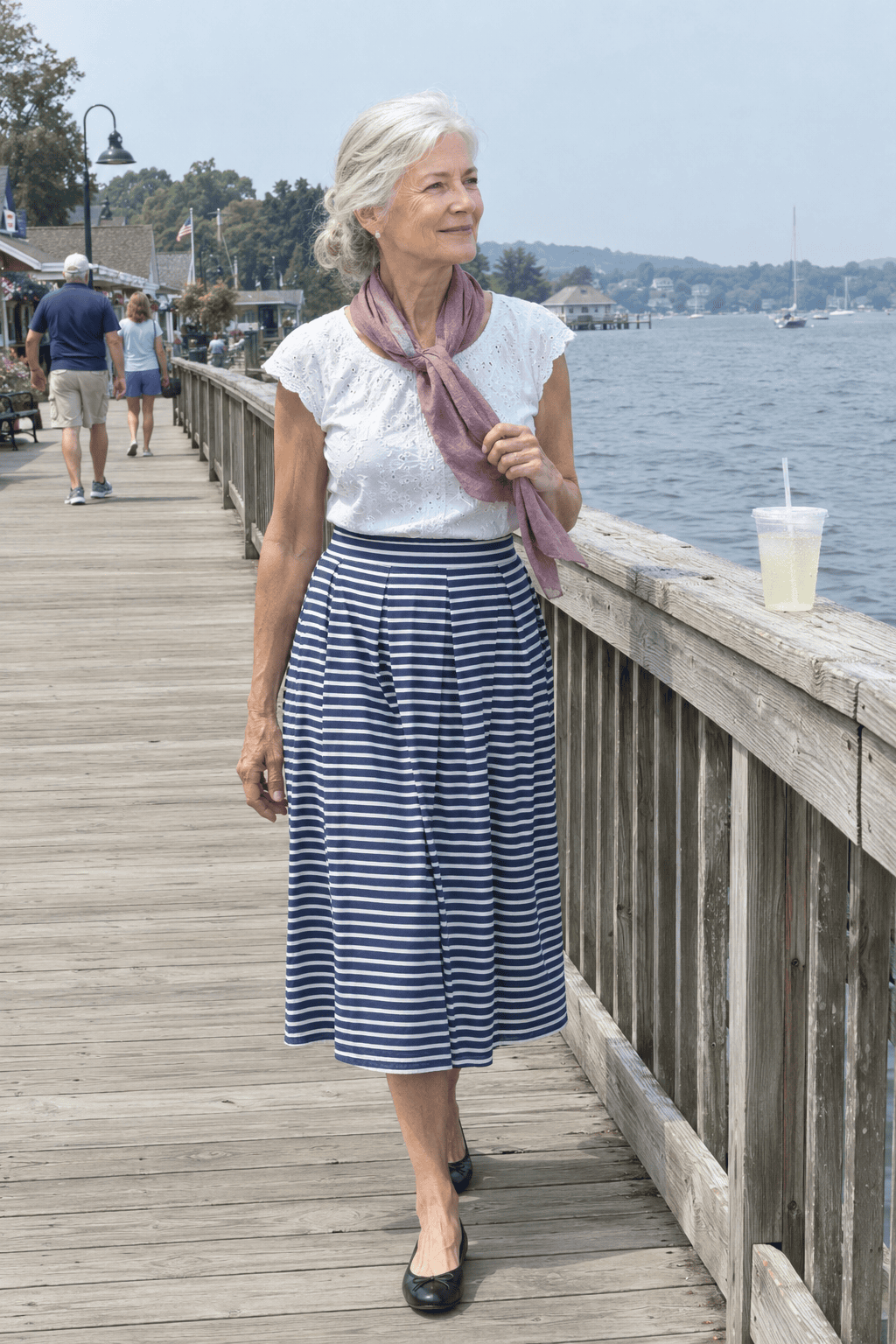 spring outfit for women over 70: navy and white sailor-stripe pleated midi skirt with a white top and cashmere silk scarf