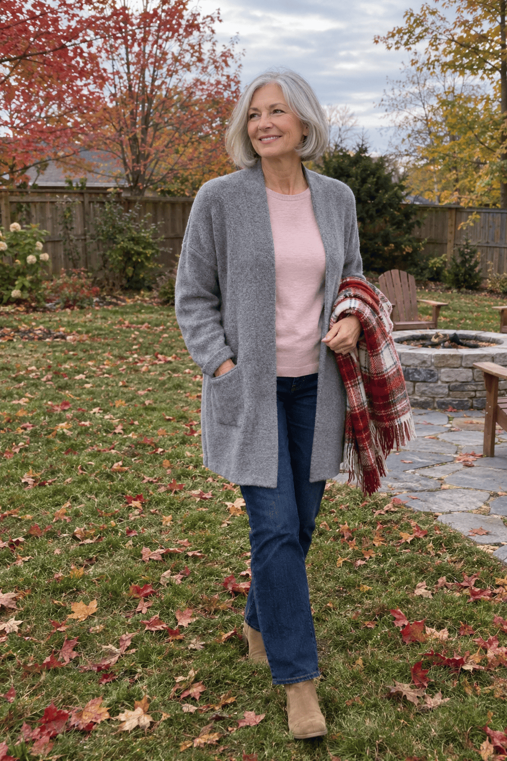 longline heather gray cardigan worn open over a soft pink long-sleeve tee with dark rinse straight jeans and tan suede ankle boots, a backyard casual outfit for women over 60