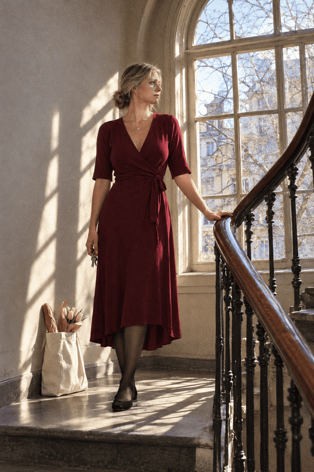 red dress outfit for Valentine's dinner at home: wine-red jersey wrap midi dress with a gold pendant necklace and sheer black tights