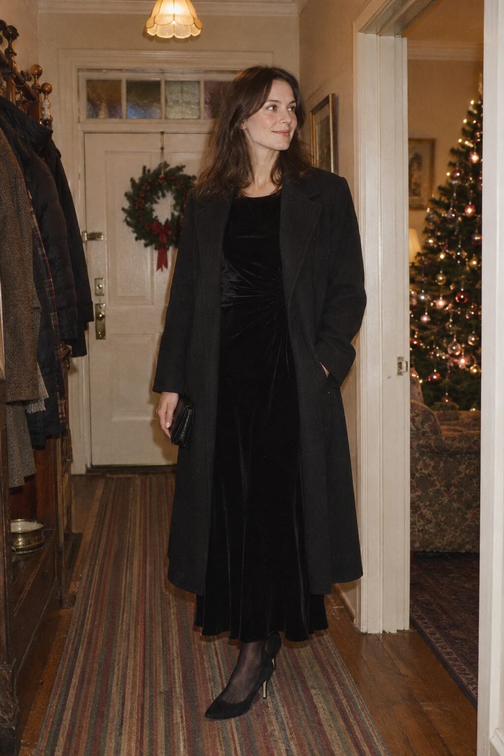 understated christmas night dinner outfit: black velvet flutter-sleeve maxi dress under an oversized black wool coat with black tights